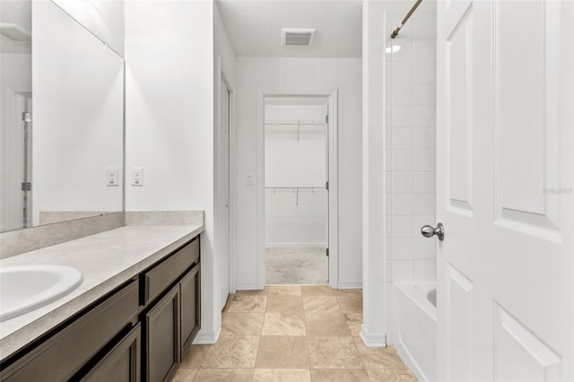 bathroom with vanity, tub / shower combination, and tile patterned flooring