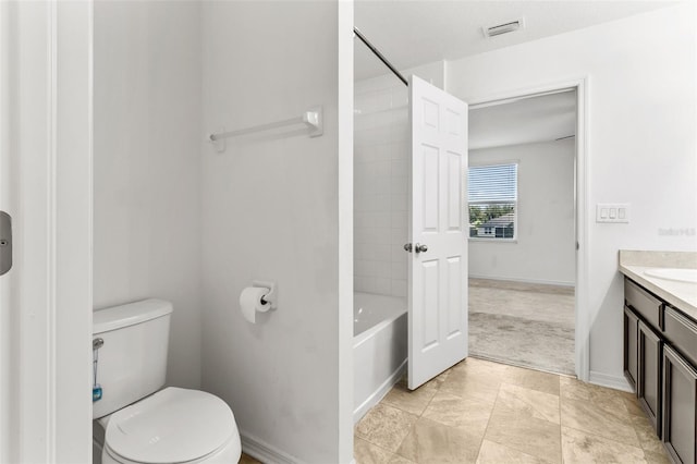 full bathroom with vanity, tiled shower / bath, tile patterned flooring, and toilet