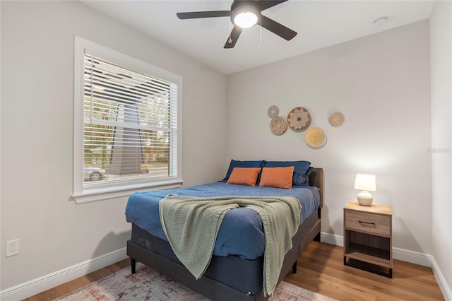 bedroom featuring hardwood / wood-style floors and ceiling fan