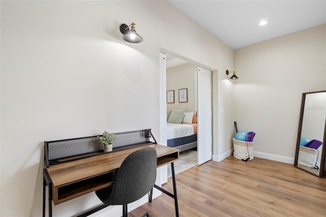 office with light wood-type flooring