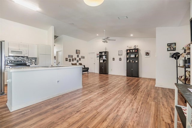 kitchen featuring ceiling fan, stainless steel appliances, light hardwood / wood-style floors, and white cabinetry