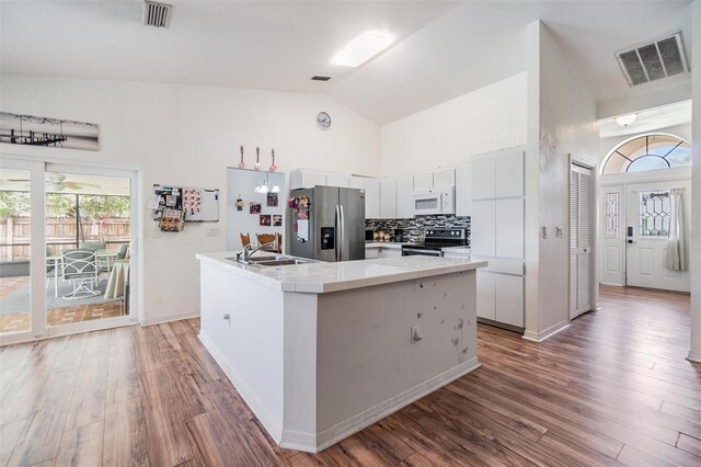 kitchen featuring hardwood / wood-style flooring, tasteful backsplash, stainless steel fridge with ice dispenser, and electric range