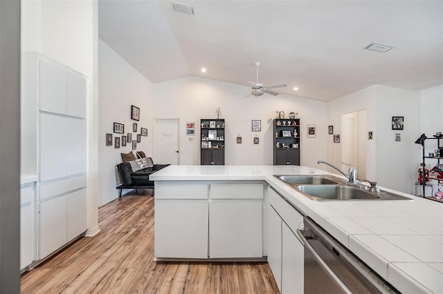 kitchen with sink, white cabinetry, light wood-type flooring, ceiling fan, and lofted ceiling