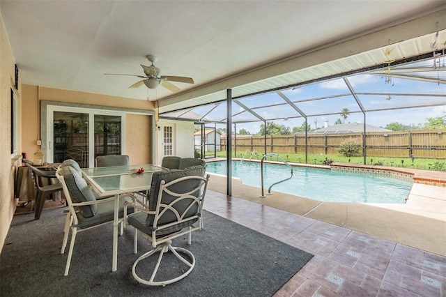 view of pool featuring ceiling fan, a patio, and a lanai