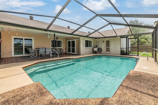 view of pool featuring ceiling fan, a patio, and a lanai