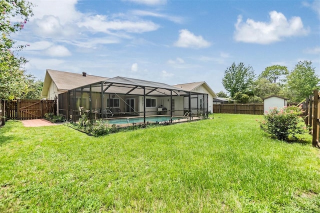 view of yard featuring a storage shed, a fenced in pool, and a lanai