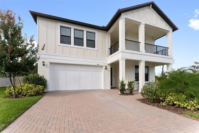 view of front of property with a garage and a balcony