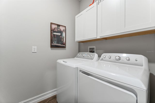 clothes washing area with independent washer and dryer, cabinets, and dark hardwood / wood-style floors