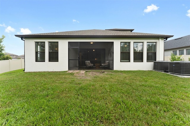 back of property featuring a yard and a sunroom