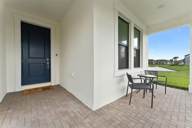 doorway to property featuring a yard