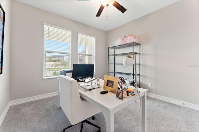 carpeted office space with ceiling fan