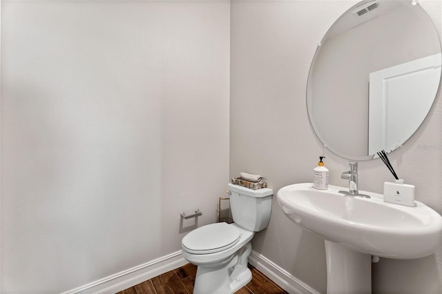 bathroom featuring sink, toilet, and hardwood / wood-style flooring