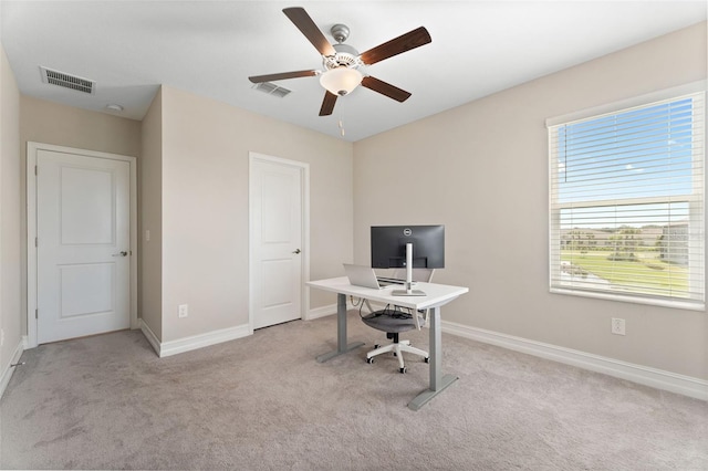 home office featuring light colored carpet and ceiling fan