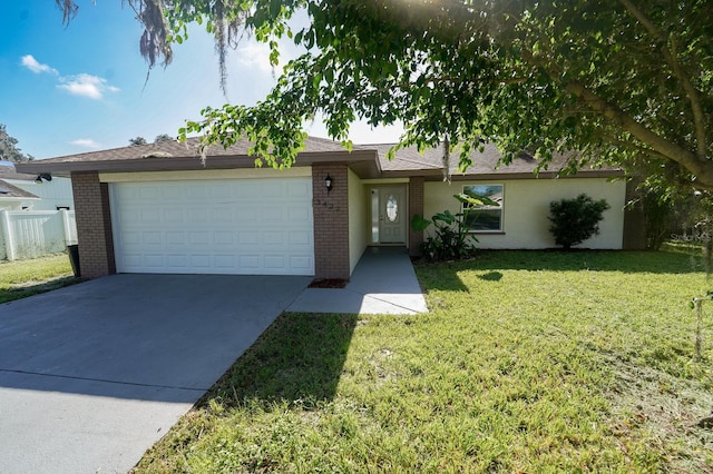 ranch-style home with an attached garage, brick siding, fence, driveway, and a front lawn