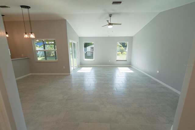 unfurnished room featuring visible vents, vaulted ceiling, baseboards, and ceiling fan