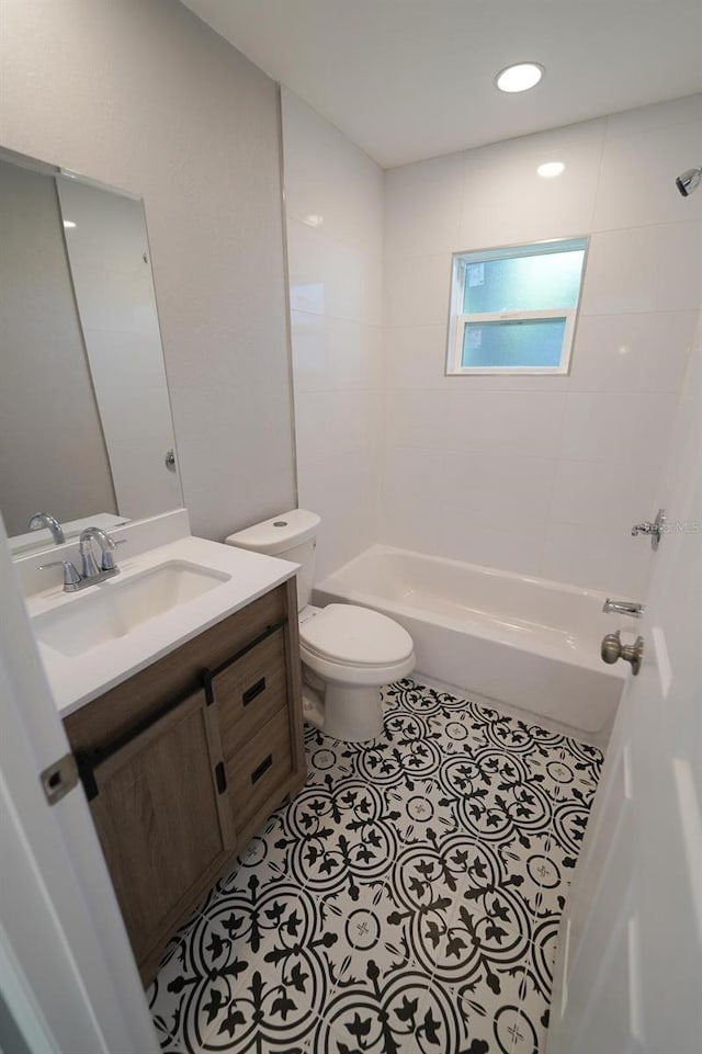 bathroom featuring toilet, tile patterned flooring, shower / bathing tub combination, and vanity