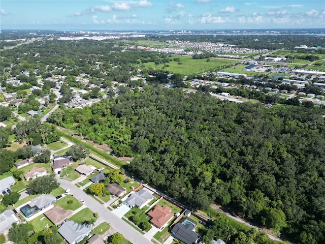 bird's eye view featuring a residential view and a wooded view