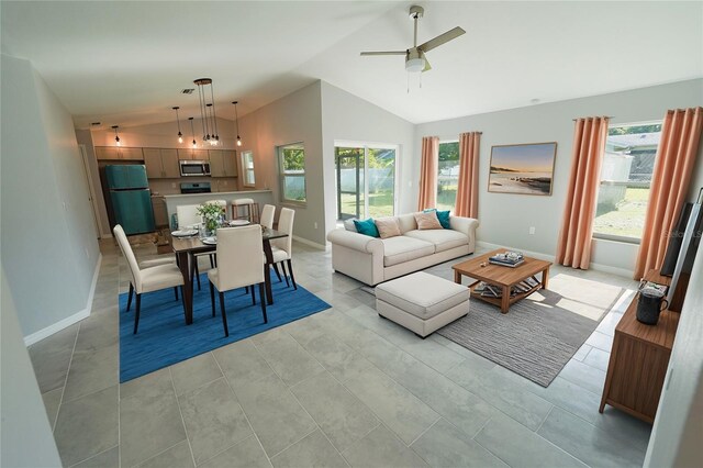 living area with high vaulted ceiling, ceiling fan, and baseboards