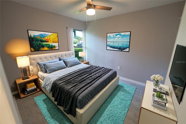 bedroom featuring baseboards, a ceiling fan, and dark tile patterned flooring