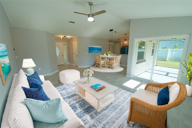 living room featuring lofted ceiling, baseboards, visible vents, and a ceiling fan