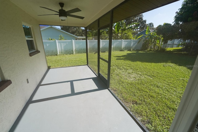 unfurnished sunroom featuring ceiling fan