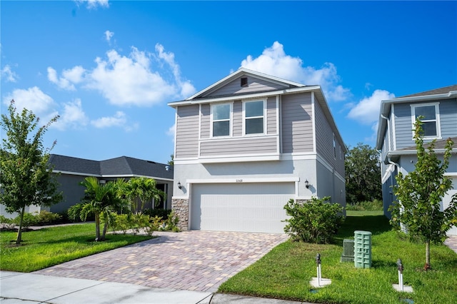 view of front property with a front lawn and a garage