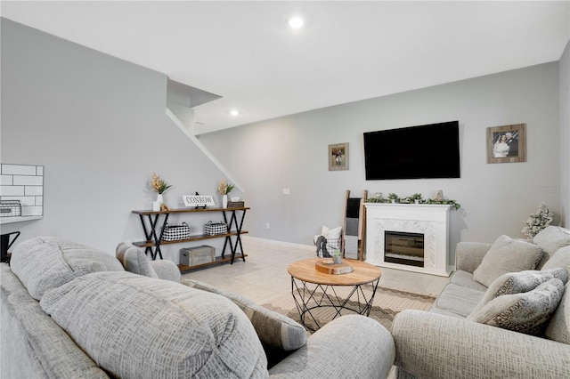 living room with light tile patterned floors and a high end fireplace