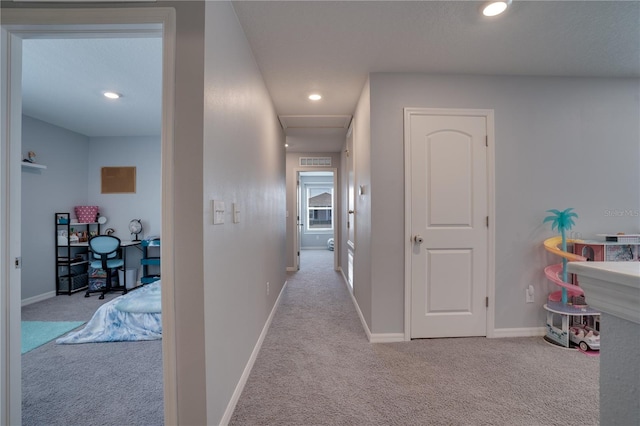 corridor with light colored carpet