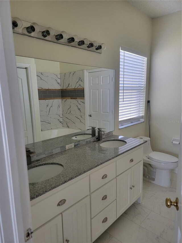 bathroom featuring vanity and toilet