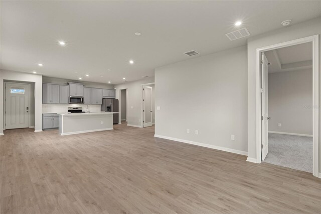 unfurnished living room with light wood-type flooring