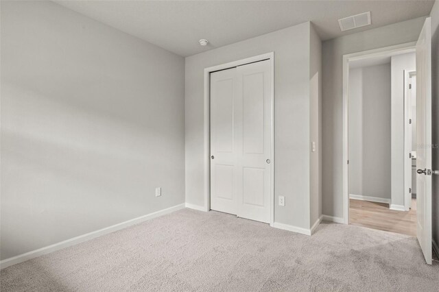 unfurnished bedroom featuring a closet and carpet floors