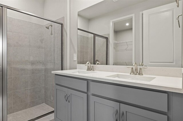 bathroom featuring vanity and a shower with door