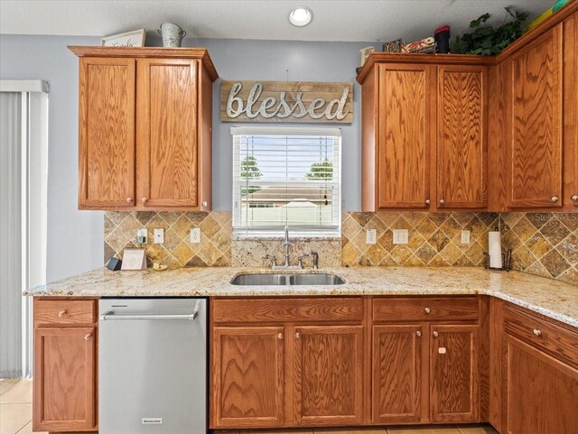 kitchen with light tile patterned floors, sink, tasteful backsplash, and dishwasher