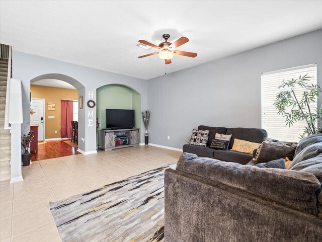 living room featuring a wealth of natural light, ceiling fan, and light tile patterned floors