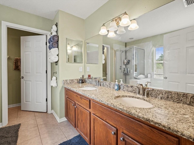 bathroom with tile patterned floors, dual vanity, and a shower with shower door