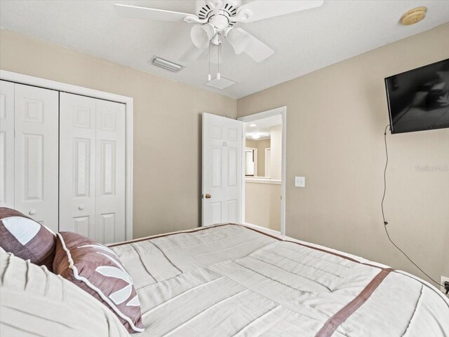 bedroom with ceiling fan and a closet