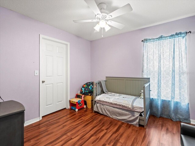 bedroom with hardwood / wood-style floors and ceiling fan