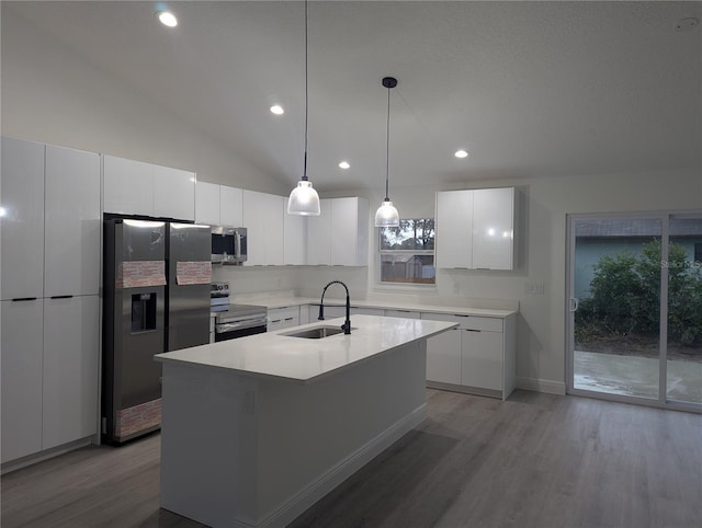 kitchen with sink, decorative light fixtures, a center island with sink, appliances with stainless steel finishes, and white cabinets