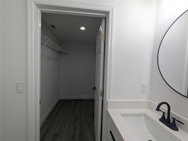 bathroom featuring hardwood / wood-style flooring and vanity