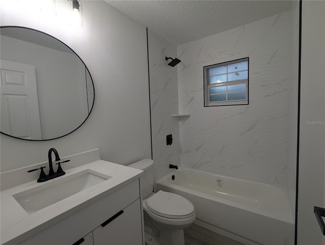 full bathroom with vanity, toilet, tiled shower / bath combo, and a textured ceiling