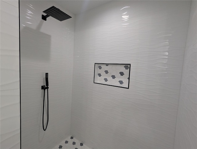 bathroom with tiled shower