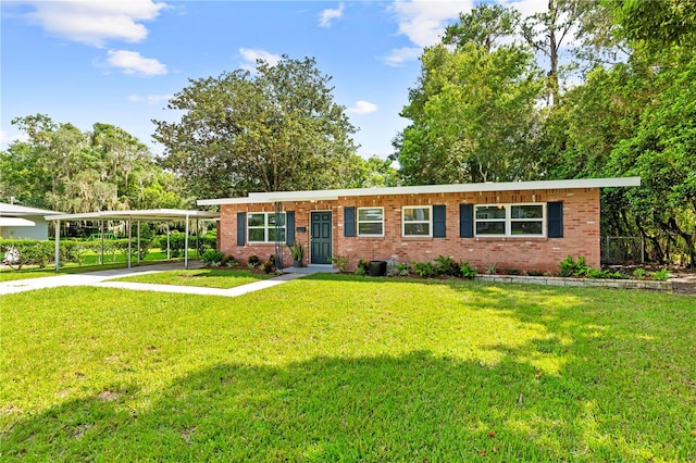 ranch-style home featuring a carport, a front yard, and central AC unit