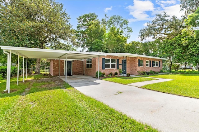 ranch-style home with a front yard and a carport