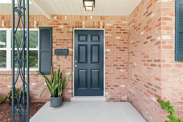 property entrance featuring brick siding