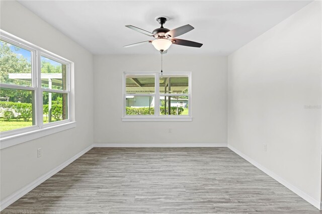 empty room featuring ceiling fan and hardwood / wood-style flooring