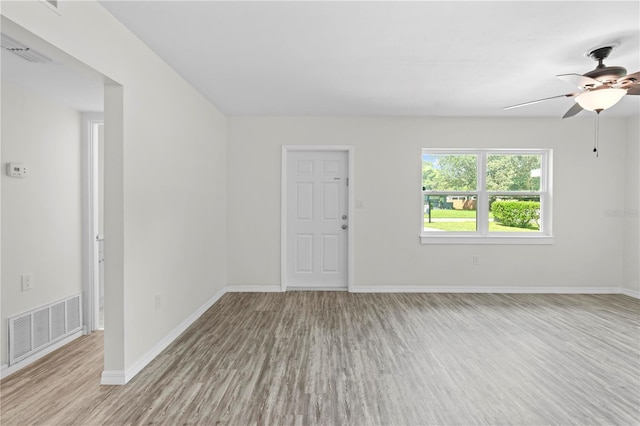 spare room with baseboards, visible vents, and light wood-style floors