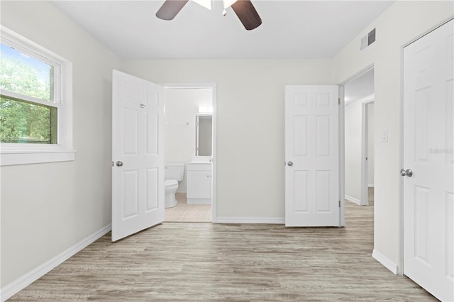 unfurnished bedroom featuring ceiling fan, connected bathroom, and light hardwood / wood-style floors