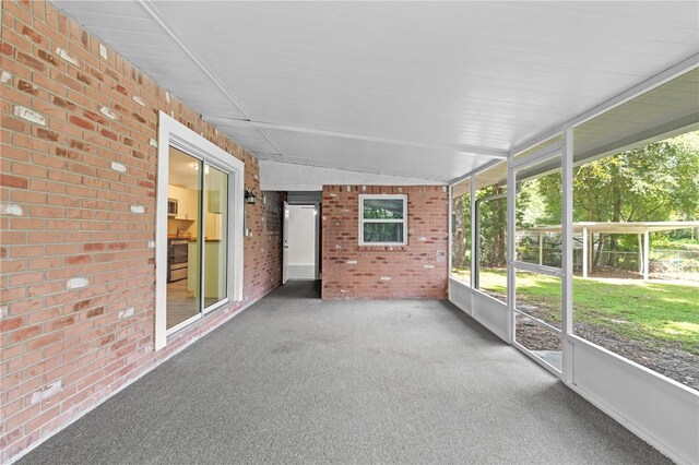 unfurnished sunroom with vaulted ceiling