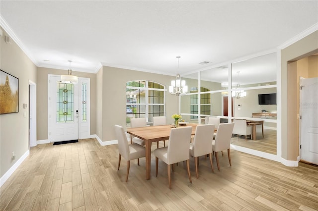 dining space with a chandelier, light hardwood / wood-style flooring, and ornamental molding