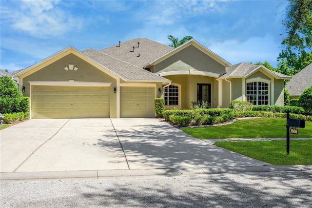 ranch-style house featuring a garage and a front lawn